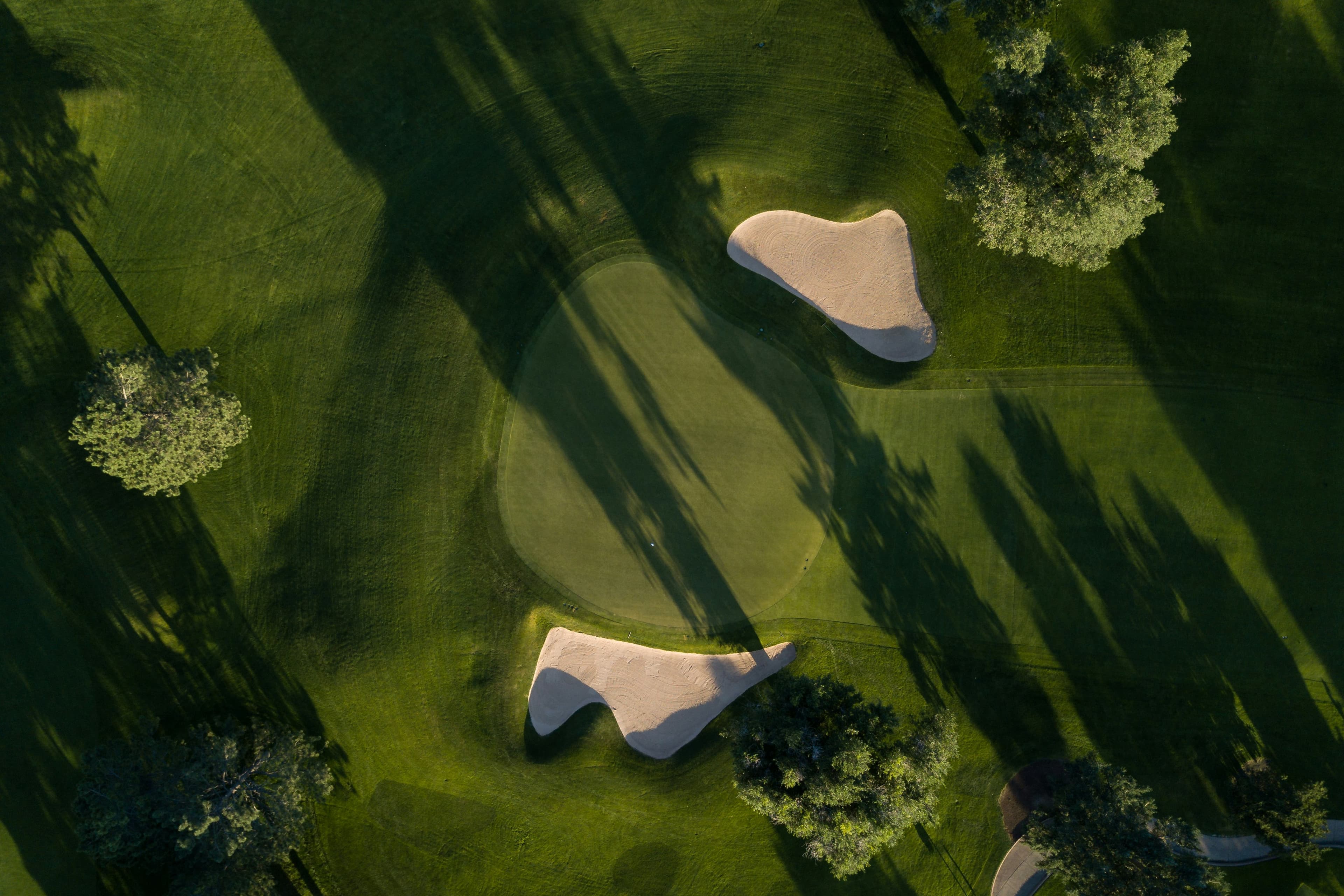 Aerial view of a golf course green with bunkers