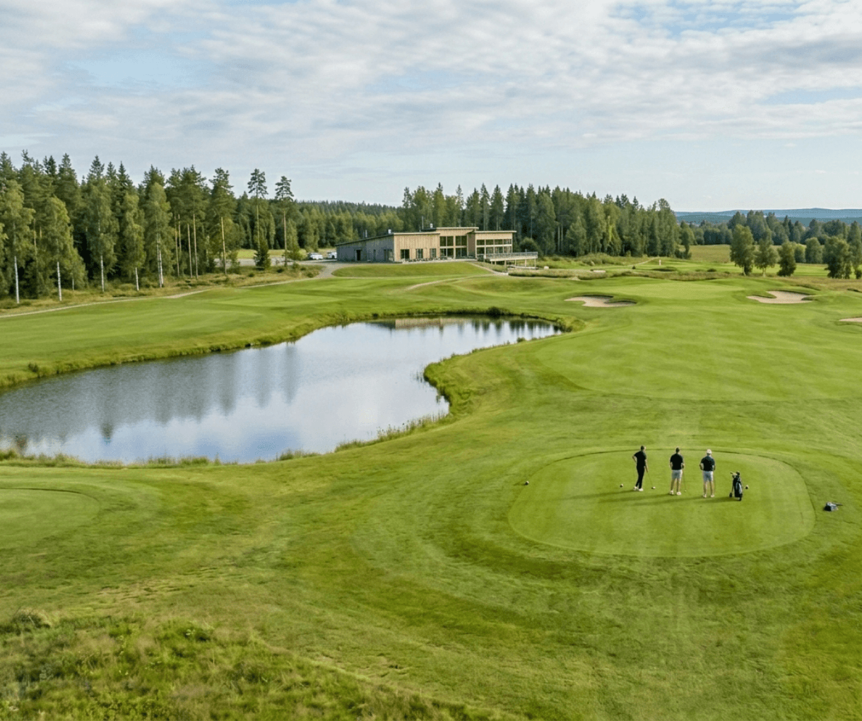 Aerial view of a golf course with players on the green